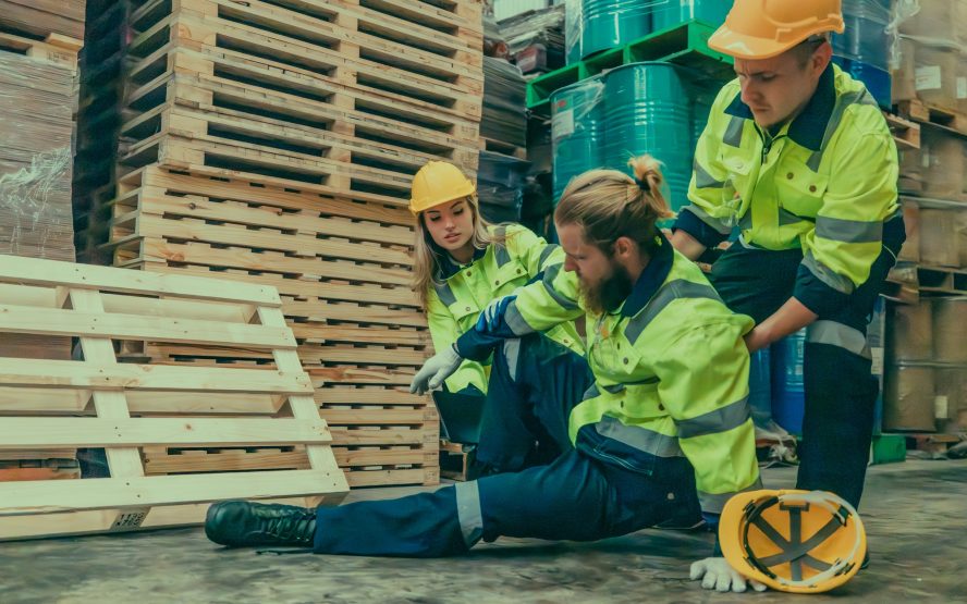 A wood factory worker's muscle injury from lifting heavy workpieces, worsened by slippery floors.